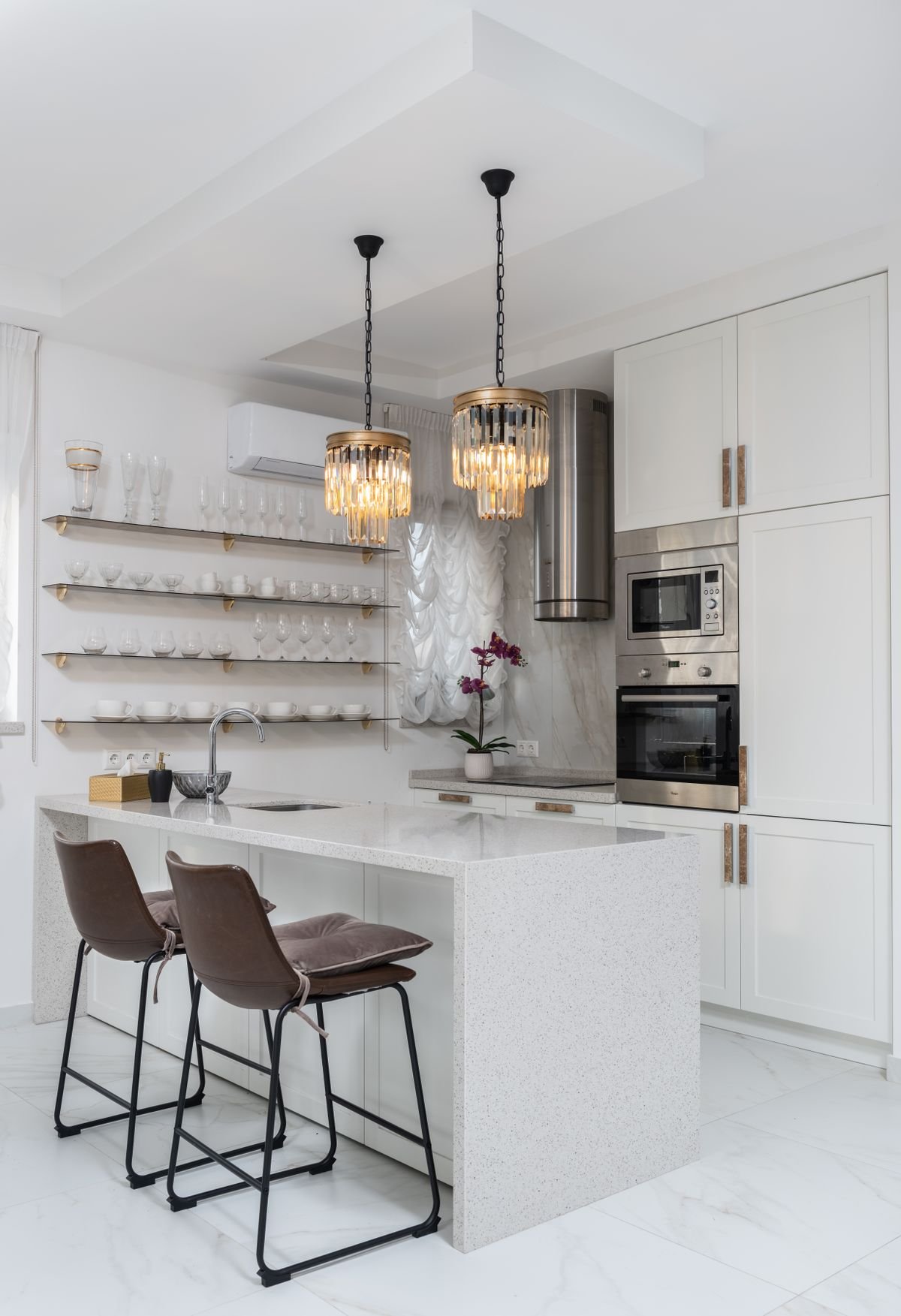 White kitchen with waterfall quartz island countertop
