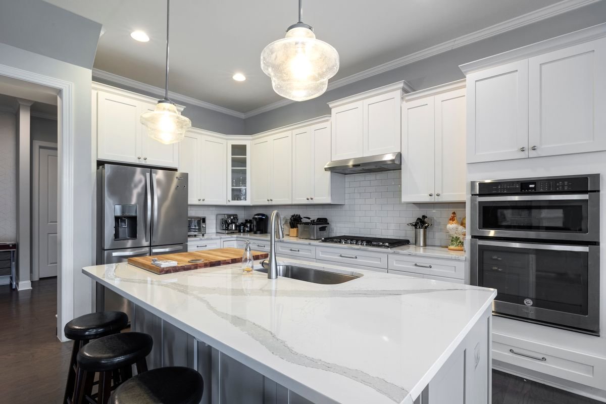 Modern white kitchen remodel with quartz island countertop